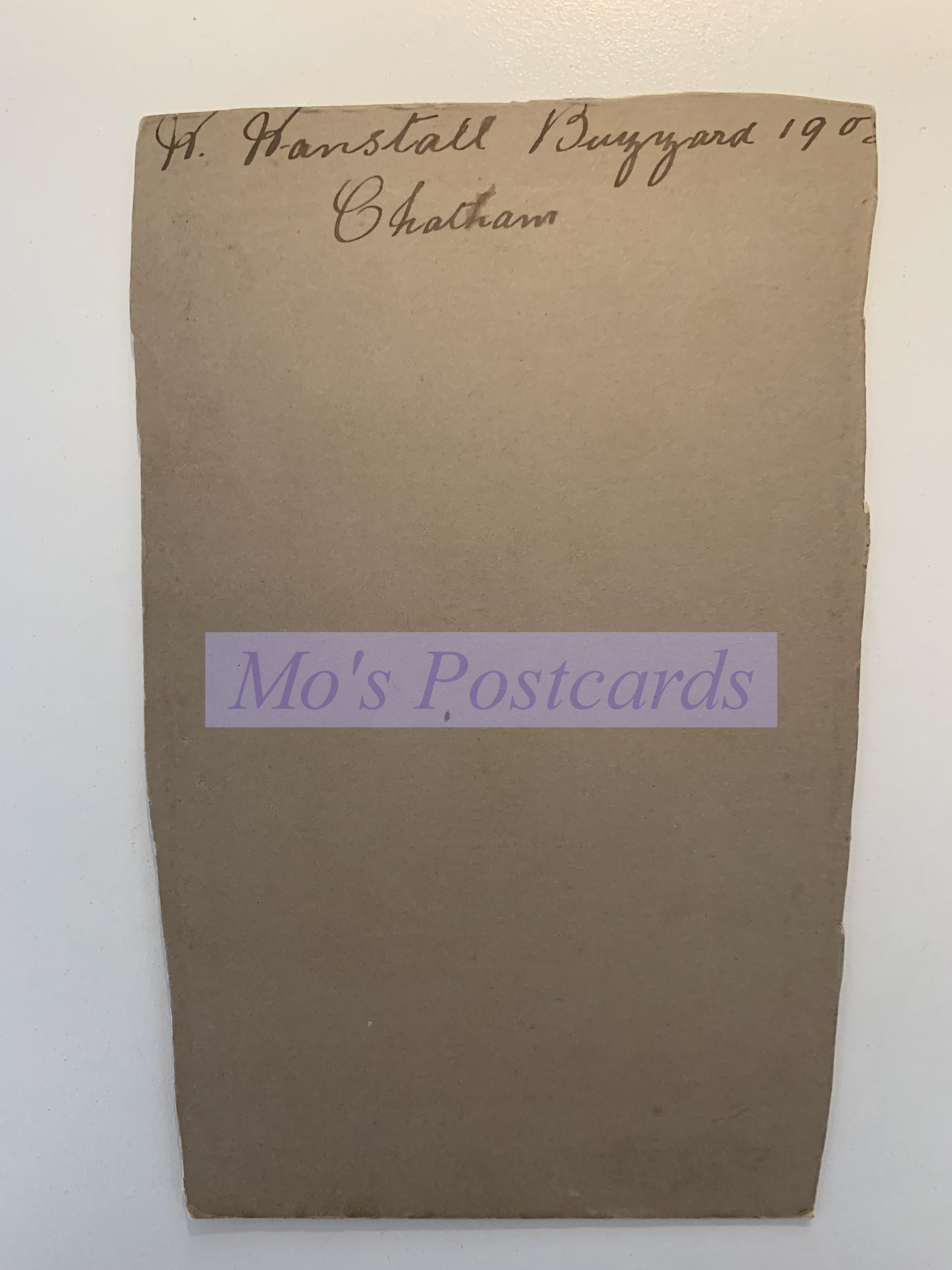 Brown envelope with 'Mo's Postcards' label on a white background