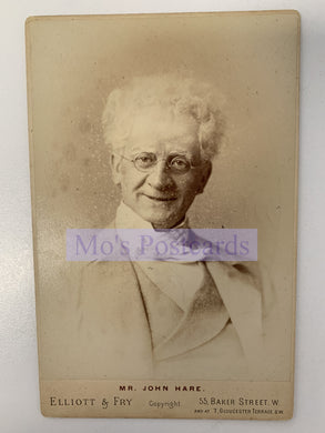 Vintage cabinet card of a man with white hair and glasses, featuring the text 'Mr. John Hare, Elliott & Fry'.