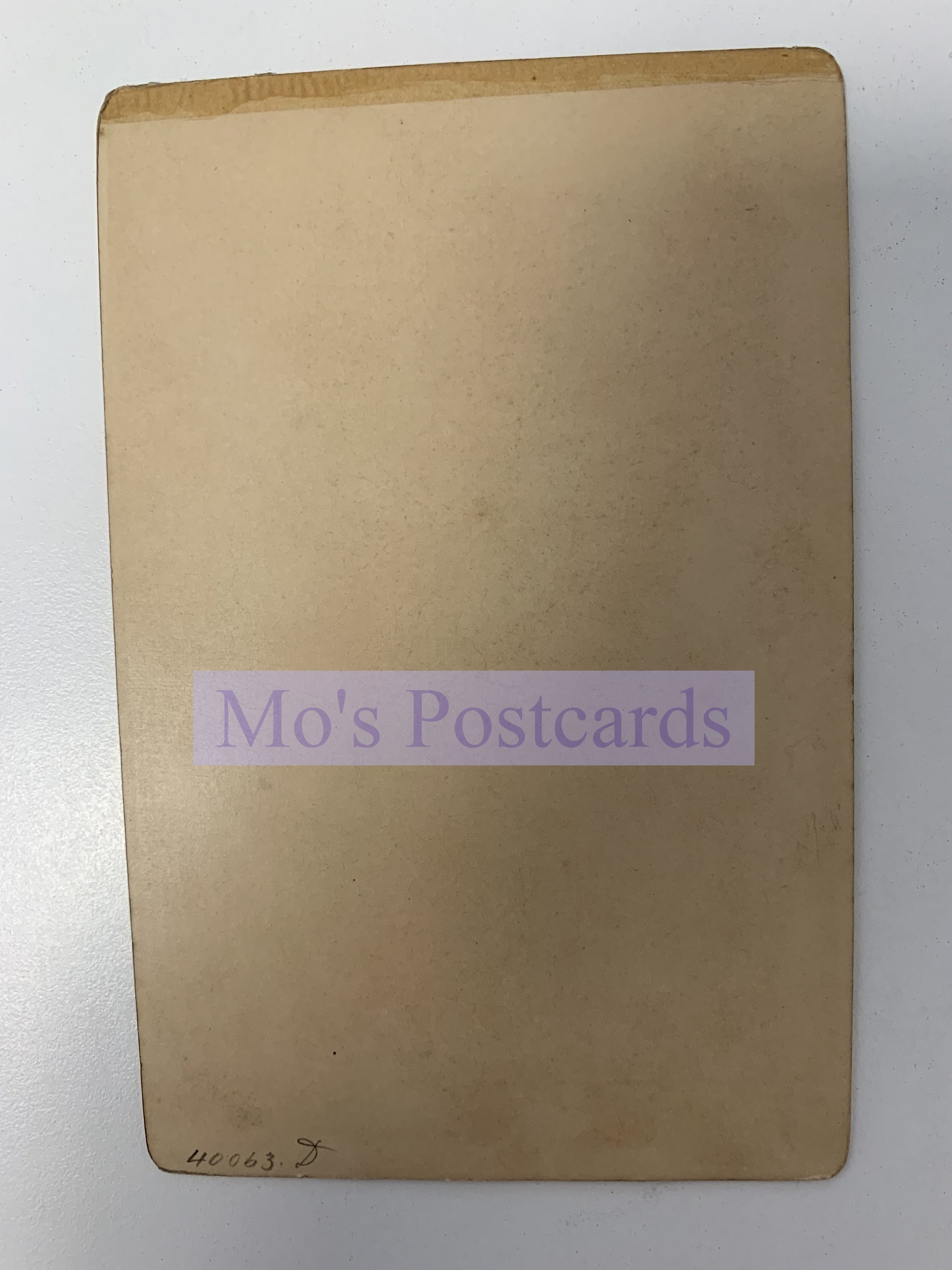 Brown envelope with 'Mo's Postcards' label on a white background