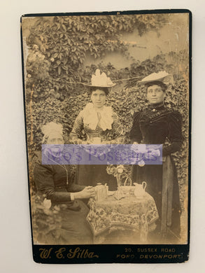 Vintage photograph of two women sitting outdoors with a table, labeled 'W. E. Silba'.