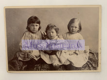 Load image into Gallery viewer, Vintage photograph of three children sitting together with a visible brand name.
